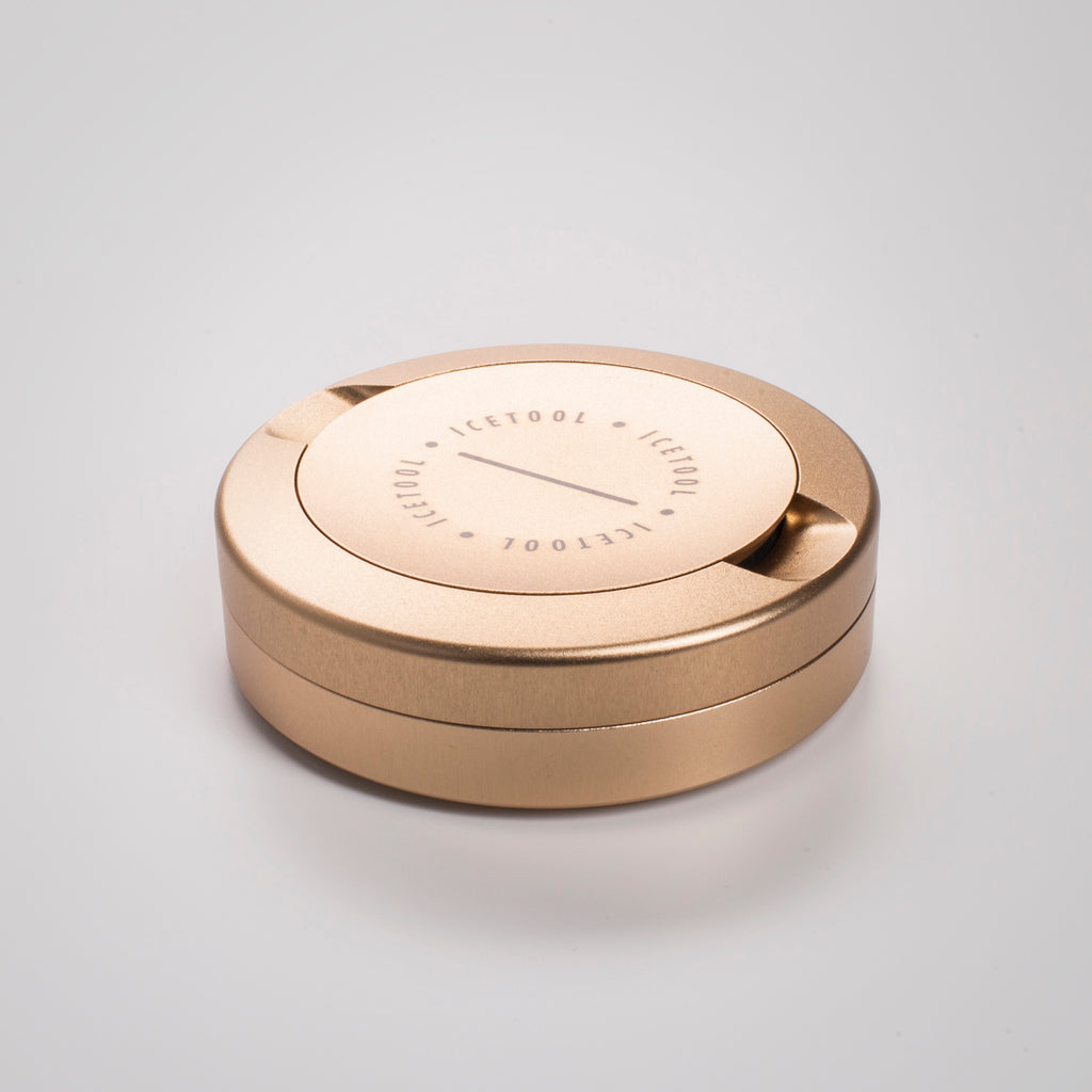 Icetool The Can golden champagne color  aluminum snus container for portion snus and nicotine pouches. Space for used portions under the lid. On a white background.