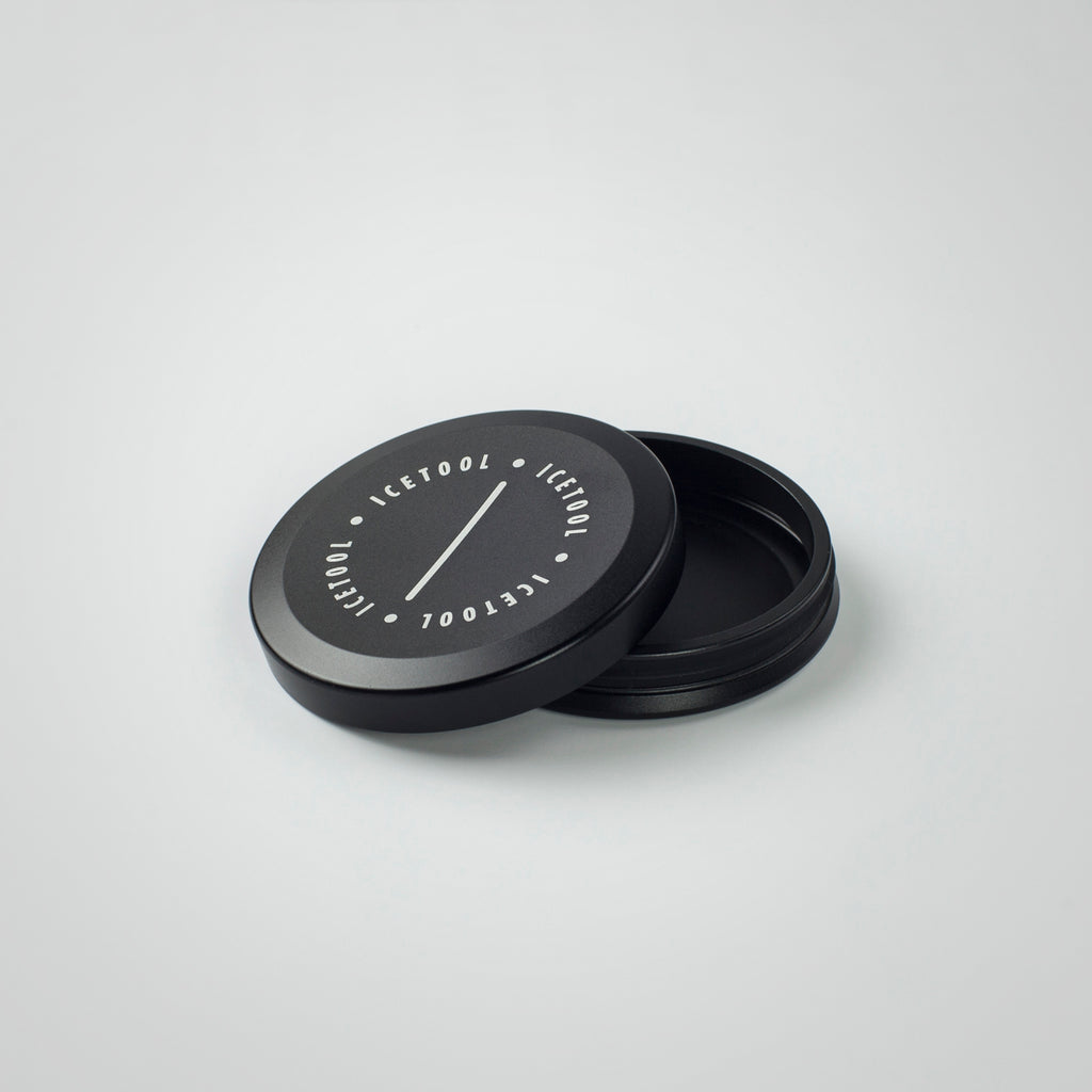 Icetool Mini Can made of black aluminum on a white background. A perfect container for nasal snus and snuff. Open.
