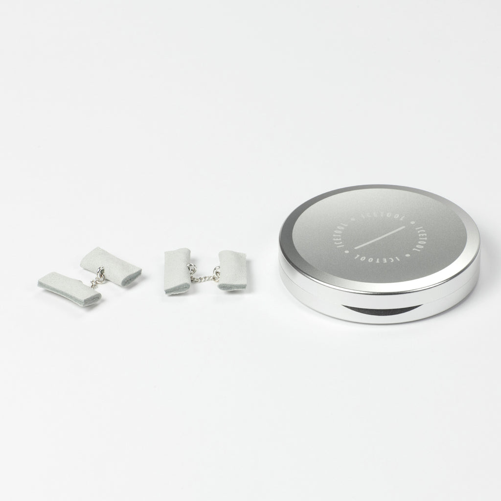 Icetool Slim Can for portion snus and nicotine pouches - Silver color anodised aluminum. On a white table with a pair of white gTie cufflinks.