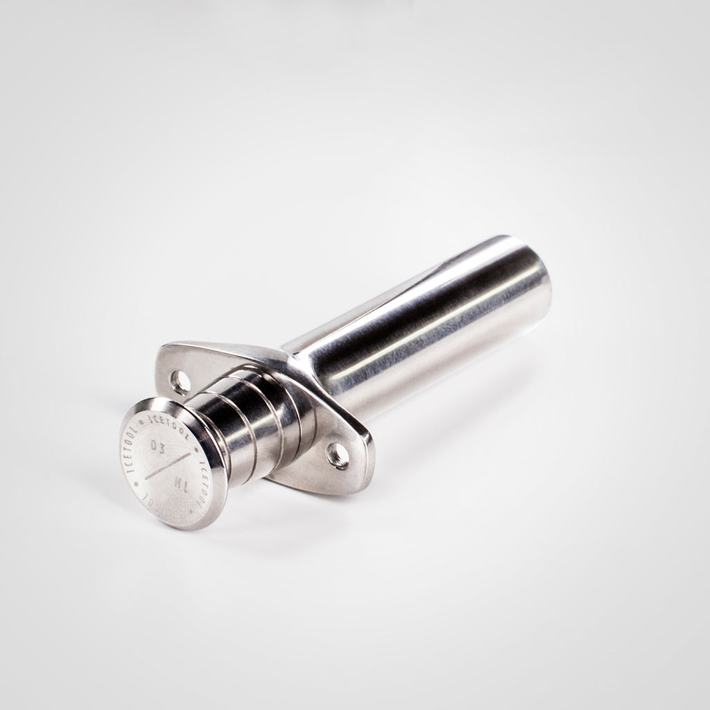 Stainless steel Icetool snus portioner on white background.